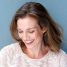 Close up portrait of a beautiful mid adult woman laughing with sweater